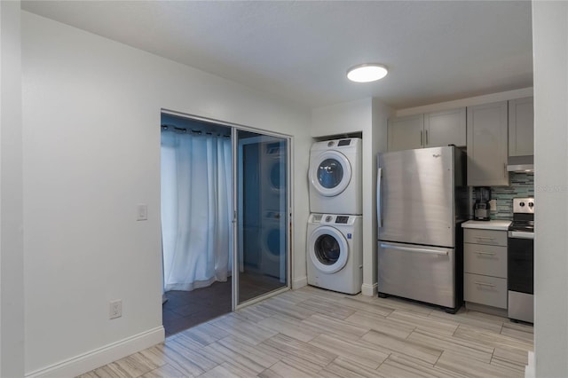 laundry room with stacked washing maching and dryer