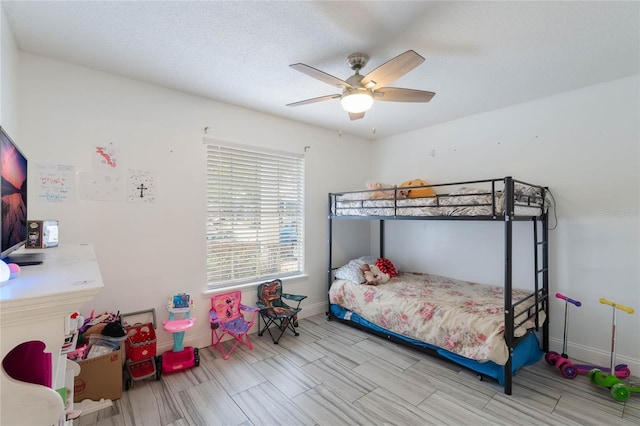 bedroom with ceiling fan and a textured ceiling