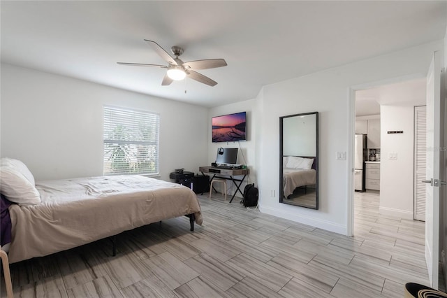 bedroom featuring ceiling fan and refrigerator