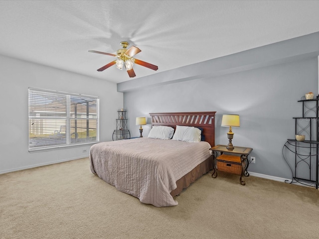 bedroom with ceiling fan and light colored carpet