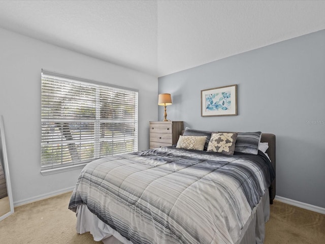 carpeted bedroom with vaulted ceiling