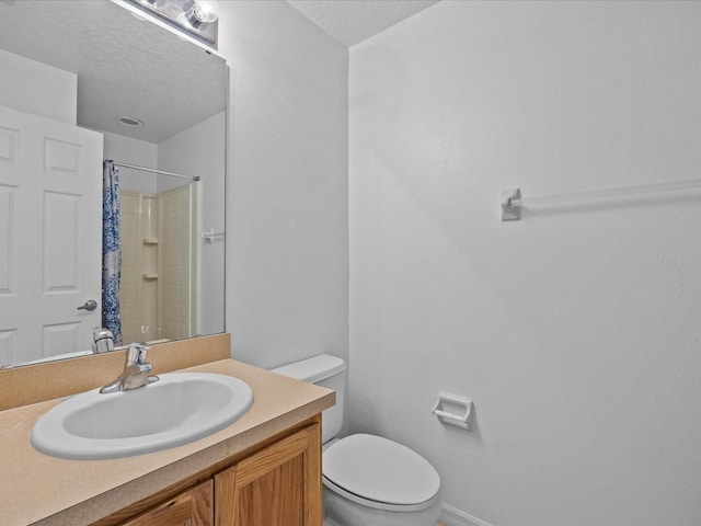 bathroom with a textured ceiling, a shower with curtain, vanity, and toilet