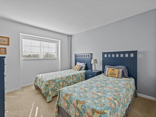 bedroom with a textured ceiling and light colored carpet