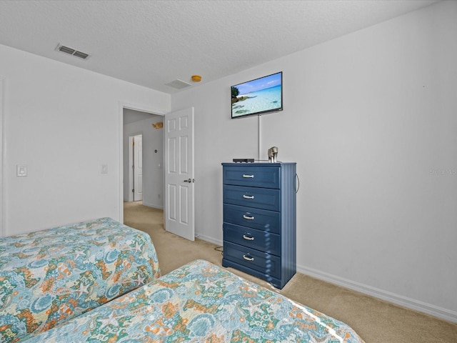 carpeted bedroom featuring a textured ceiling