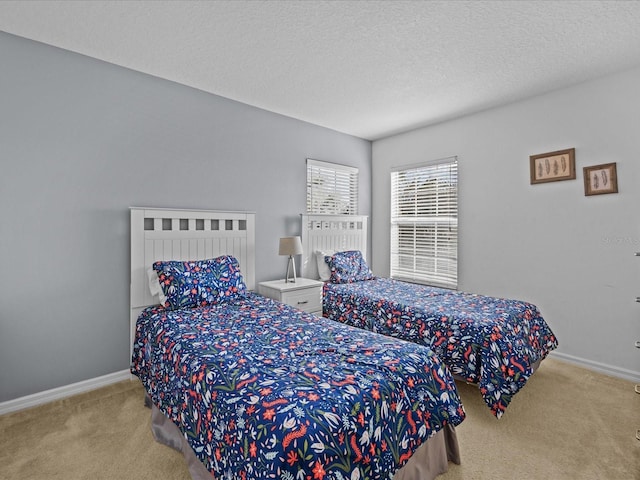 bedroom with light colored carpet and a textured ceiling