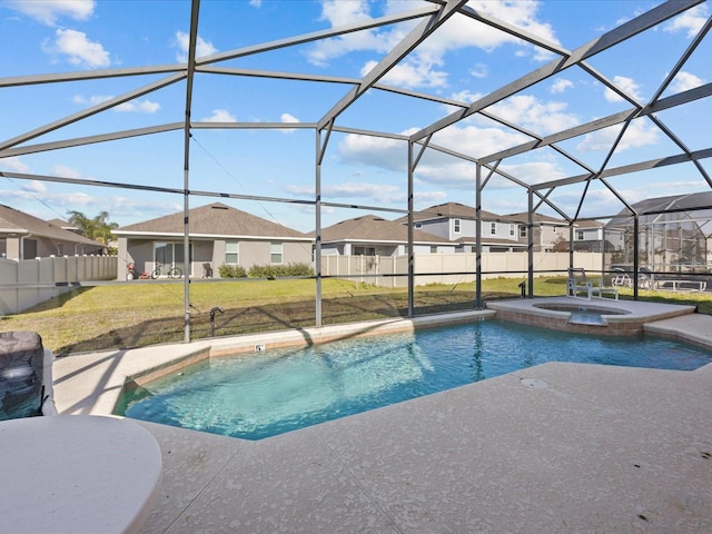 view of pool featuring a yard, an in ground hot tub, glass enclosure, and a patio area