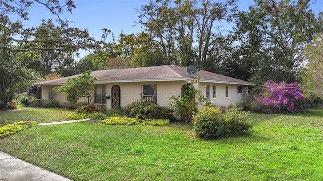 ranch-style home featuring a front yard