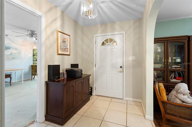 entryway with ceiling fan and light colored carpet