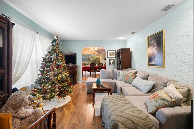 living room featuring a chandelier and hardwood / wood-style flooring