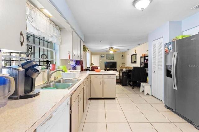 kitchen with white dishwasher, sink, stainless steel refrigerator with ice dispenser, ceiling fan, and kitchen peninsula