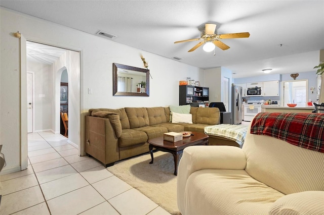 living room featuring light tile patterned floors and ceiling fan