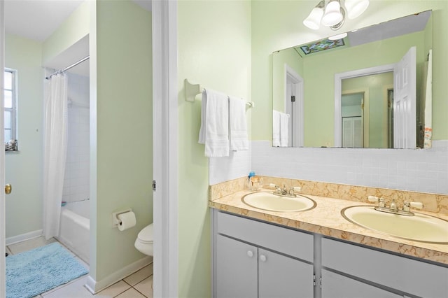 full bathroom with vanity, backsplash, tile patterned flooring, toilet, and shower / tub combo