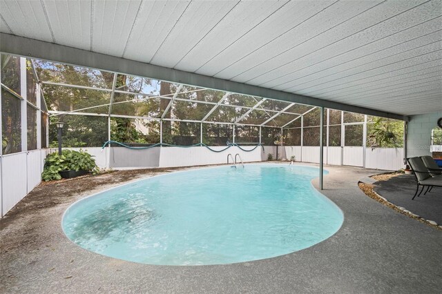 view of pool with glass enclosure