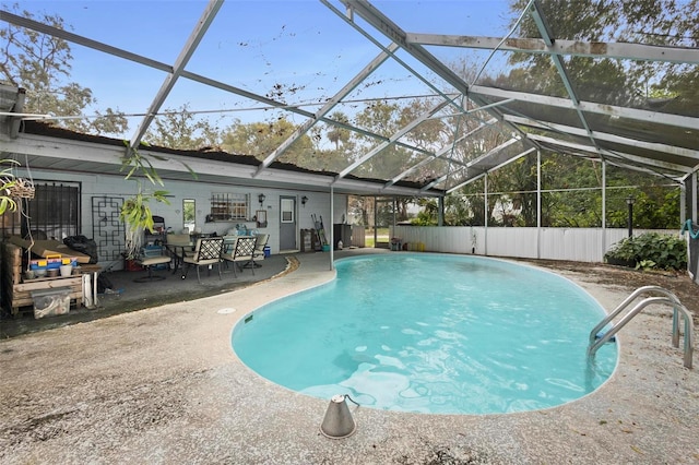 view of swimming pool with a patio area and glass enclosure