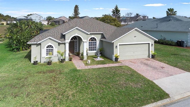 ranch-style house with a garage and a front lawn