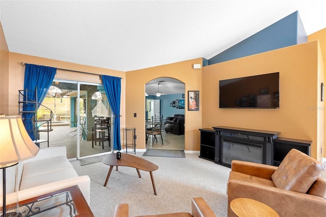 carpeted living room featuring ceiling fan and lofted ceiling