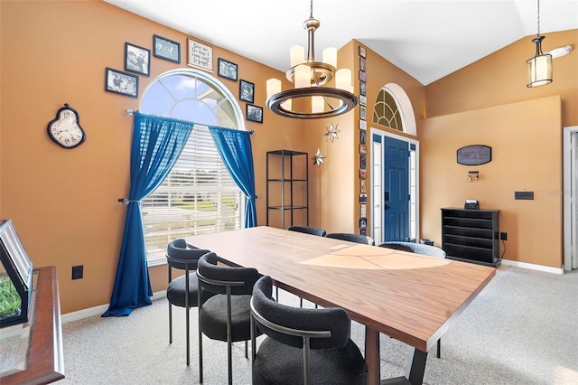 dining area featuring light carpet, vaulted ceiling, and a notable chandelier