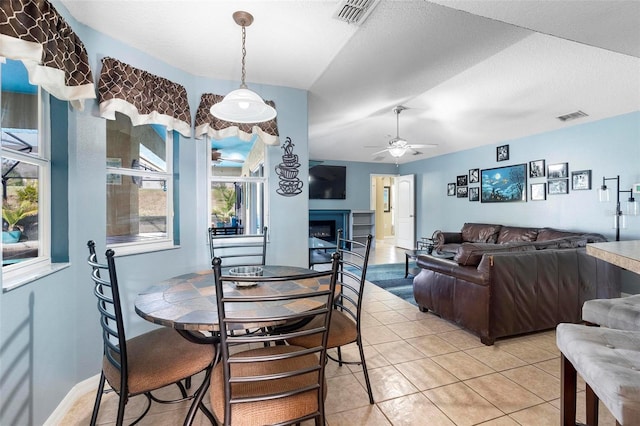 dining room with light tile patterned floors, a textured ceiling, and ceiling fan