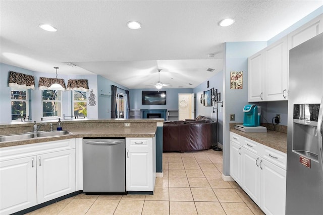 kitchen featuring pendant lighting, sink, white cabinets, and stainless steel appliances