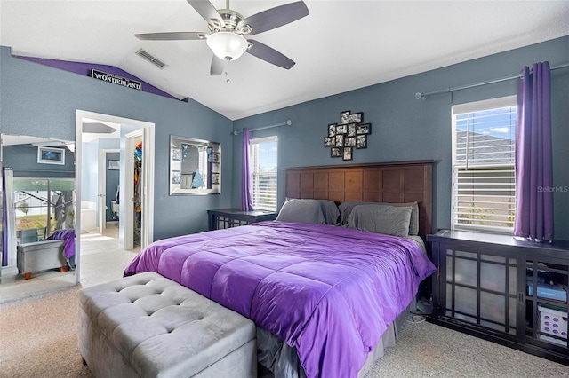 bedroom featuring light colored carpet, vaulted ceiling, and ceiling fan