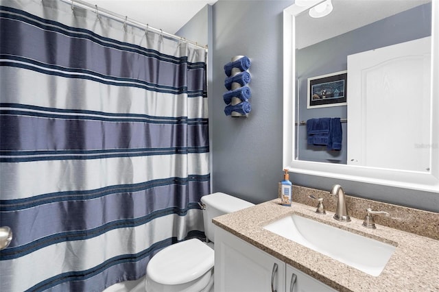 bathroom with a shower with curtain, vanity, and toilet