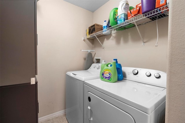 washroom with washing machine and dryer and light tile patterned floors