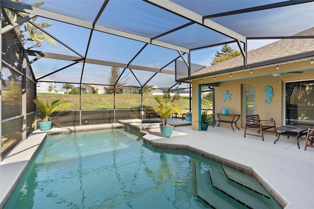 view of swimming pool with a lanai and a patio