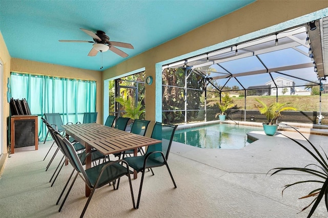 view of pool featuring a lanai, ceiling fan, and a patio area