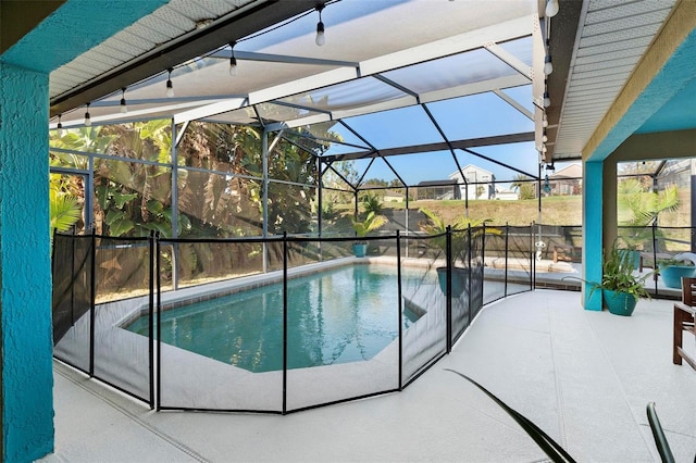 view of pool with a patio area and a lanai