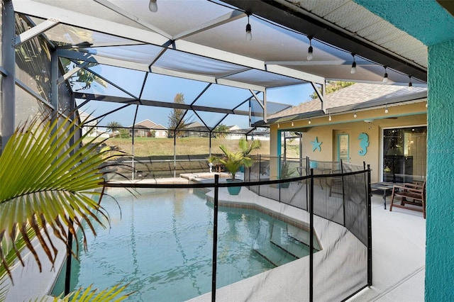 view of swimming pool featuring a patio and glass enclosure