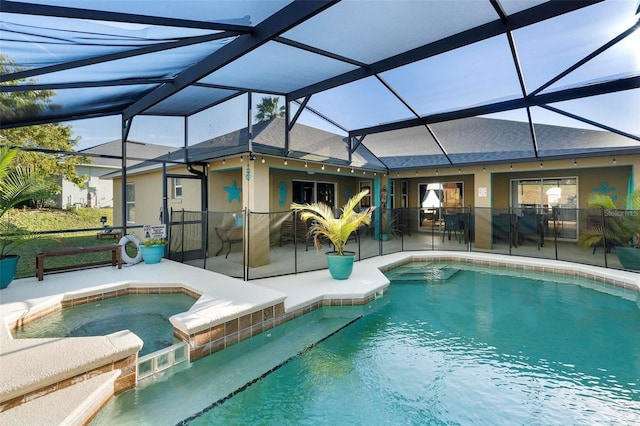 view of pool with an in ground hot tub, a patio, and a lanai