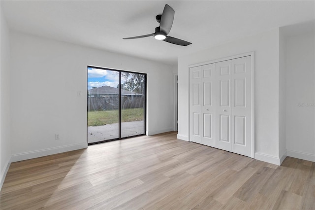 5355 Fay Blvd, Cocoa, FL 32927 - unfurnished bedroom featuring baseboards, access to exterior, and light wood-style floors