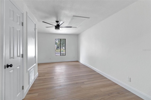5355 Fay Blvd, Cocoa, FL 32927 - empty room featuring light wood-style floors, a textured ceiling, a ceiling fan, and baseboards