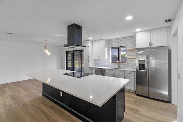 5355 Fay Blvd, Cocoa, FL 32927 - kitchen featuring tasteful backsplash, a sink, island range hood, stainless steel appliances, and white cabinetry