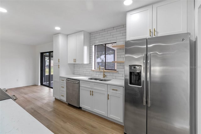 5355 Fay Blvd, Cocoa, FL 32927 - kitchen with a sink, white cabinetry, backsplash, light countertops, and appliances with stainless steel finishes