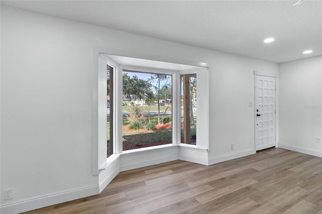 5355 Fay Blvd, Cocoa, FL 32927 - unfurnished room featuring baseboards, wood finished floors, and recessed lighting