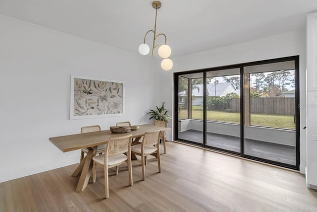 5355 Fay Blvd, Cocoa, FL 32927 - dining space with baseboards, an inviting chandelier, and light wood-style floors