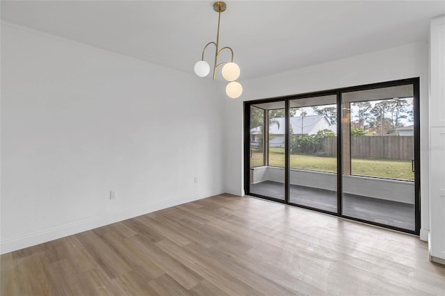 5355 Fay Blvd, Cocoa, FL 32927 - spare room featuring baseboards, an inviting chandelier, and light wood-type flooring