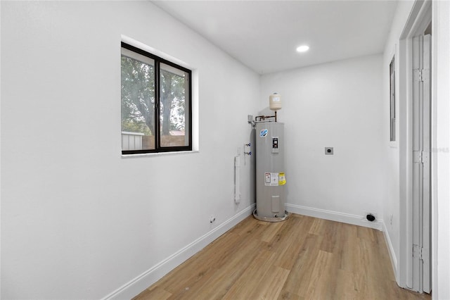 5355 Fay Blvd, Cocoa, FL 32927 - washroom with light wood-style flooring, hookup for an electric dryer, electric water heater, baseboards, and laundry area