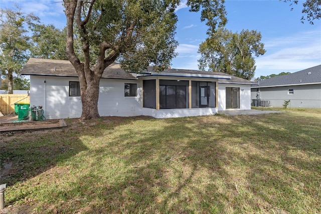 5355 Fay Blvd, Cocoa, FL 32927 - back of house featuring a lawn, concrete block siding, fence, a sunroom, and roof with shingles