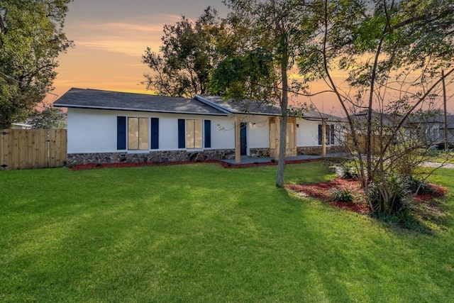 5355 Fay Blvd, Cocoa, FL 32927 - view of front of house featuring fence, a lawn, and stucco siding