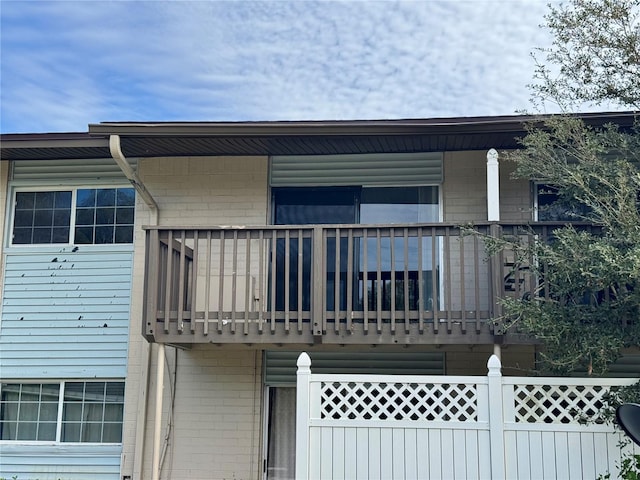 back of property with a balcony