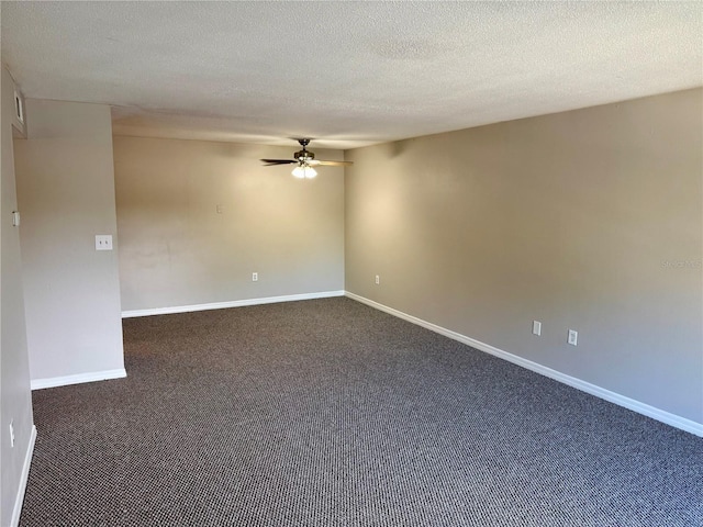 carpeted spare room featuring ceiling fan and a textured ceiling