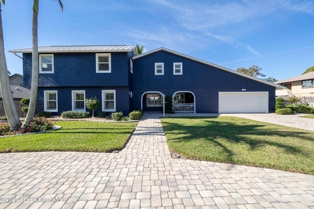 view of front of home featuring a porch, a garage, and a front yard