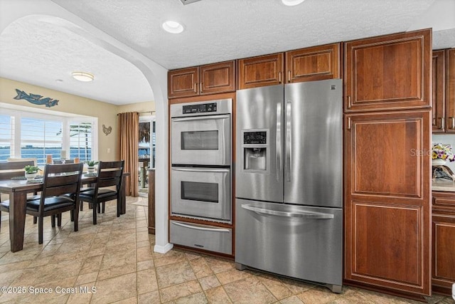 kitchen featuring a textured ceiling and appliances with stainless steel finishes