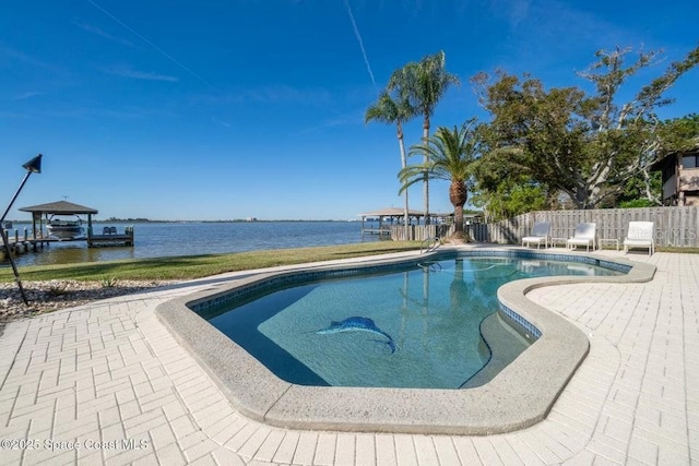 view of swimming pool with a patio and a water view