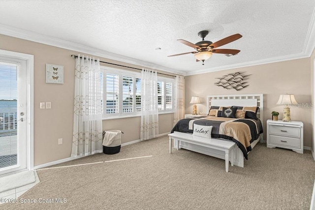 carpeted bedroom with multiple windows, a textured ceiling, ceiling fan, and ornamental molding