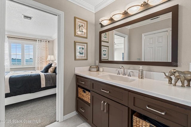 bathroom featuring vanity, a textured ceiling, and crown molding