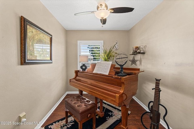 miscellaneous room featuring hardwood / wood-style flooring, ceiling fan, and a textured ceiling