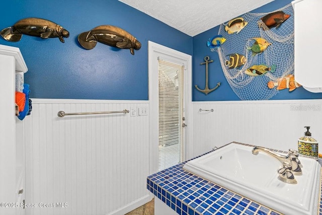 bathroom featuring sink and a textured ceiling